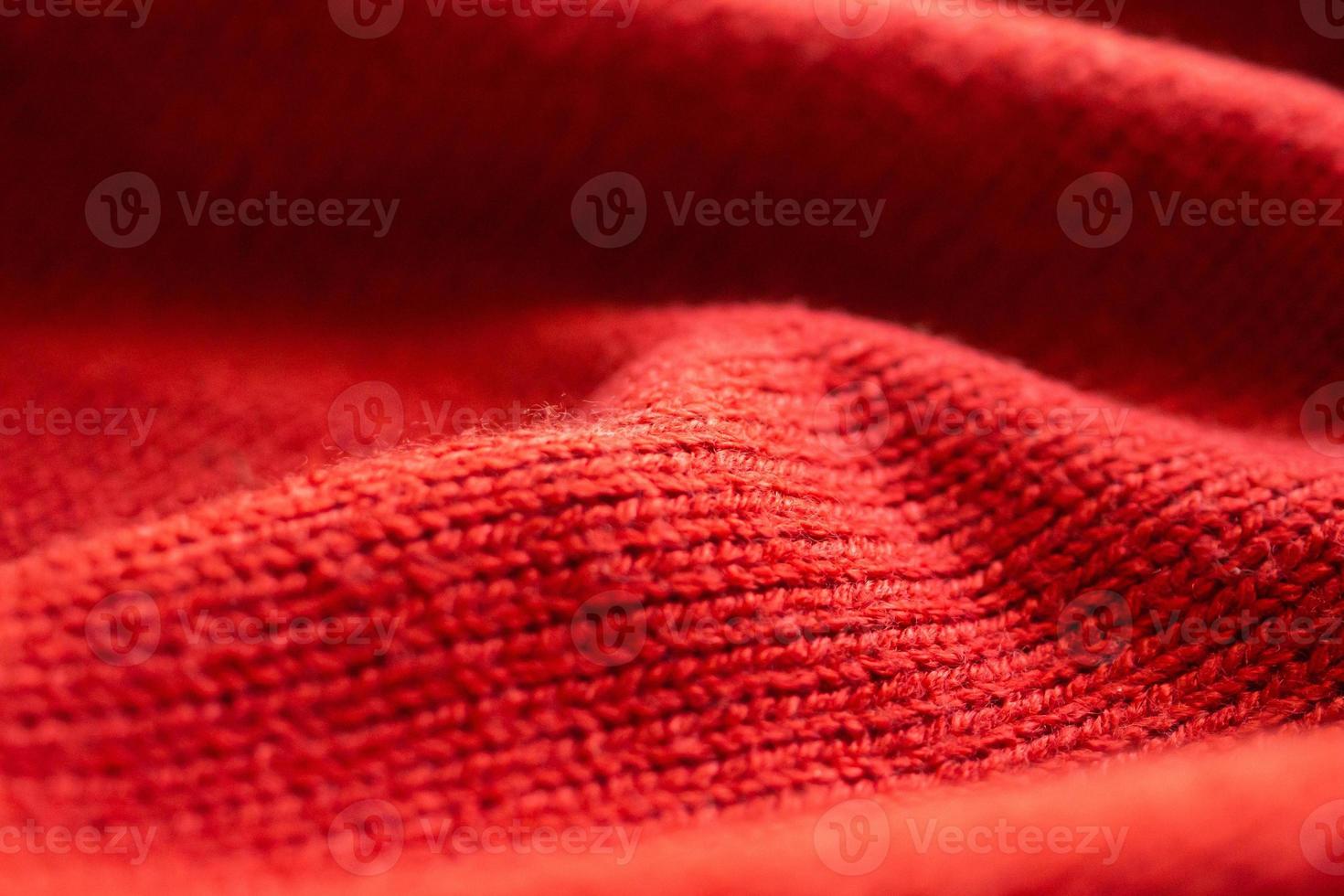 closeup red knitted woolen fabric texture background photo