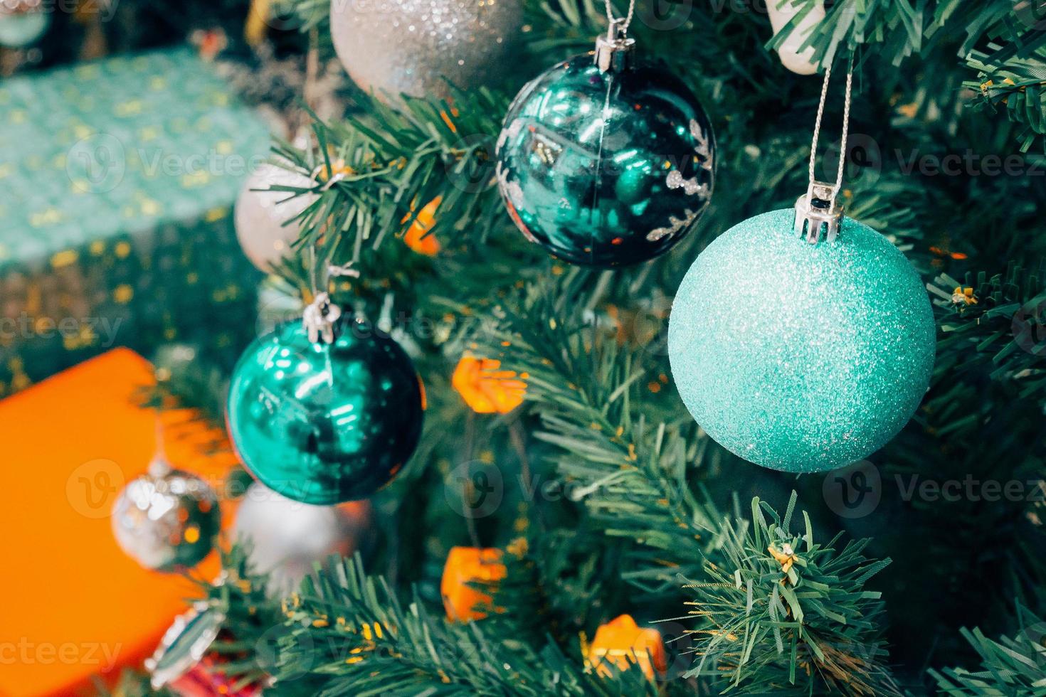 Decorated Christmas tree with colorful bauble on sparkling bokeh light blurred background photo