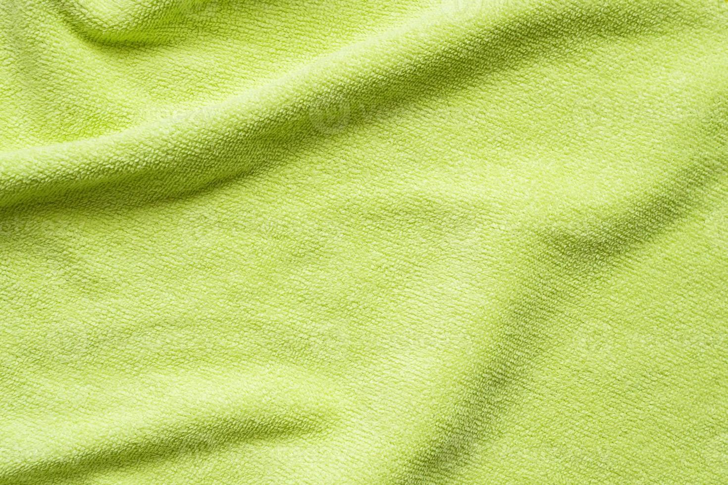 Green towel fabric texture surface close up background photo