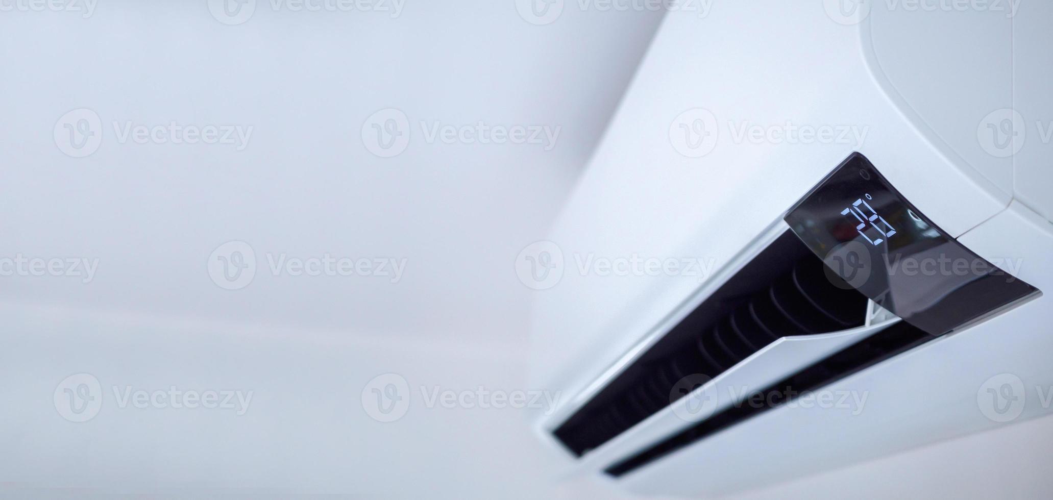 Air conditioner on white wall room interior background photo