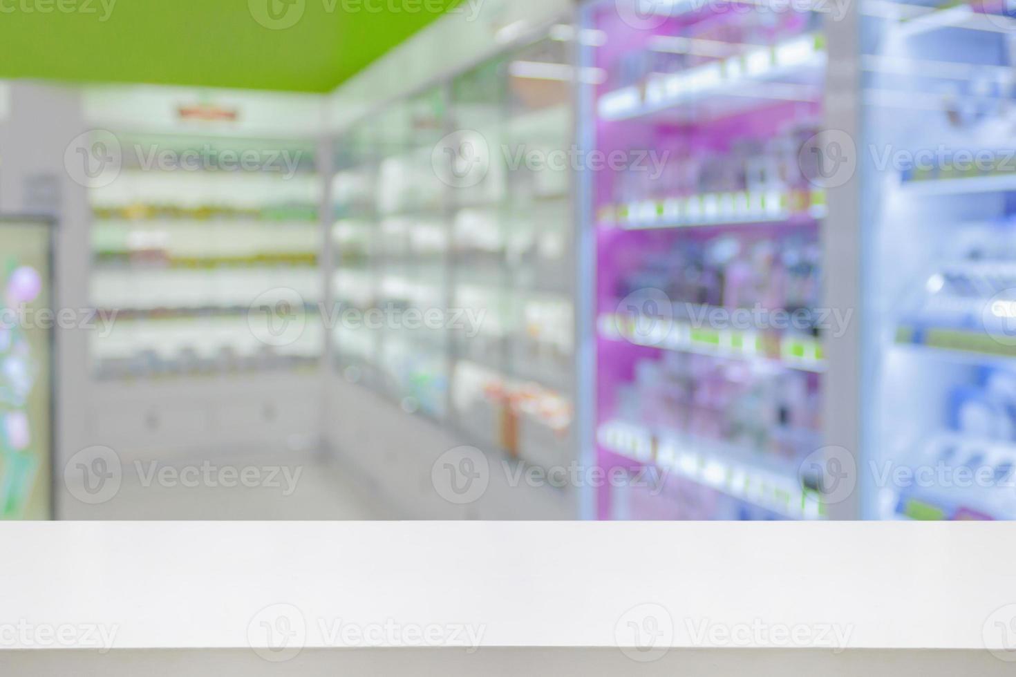 Empty white counter with pharmacy drugstore shelves blurred background photo