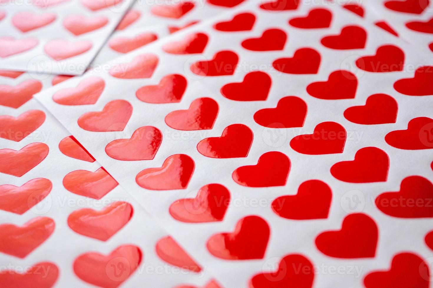 Close up red heart sticker on white paper photo