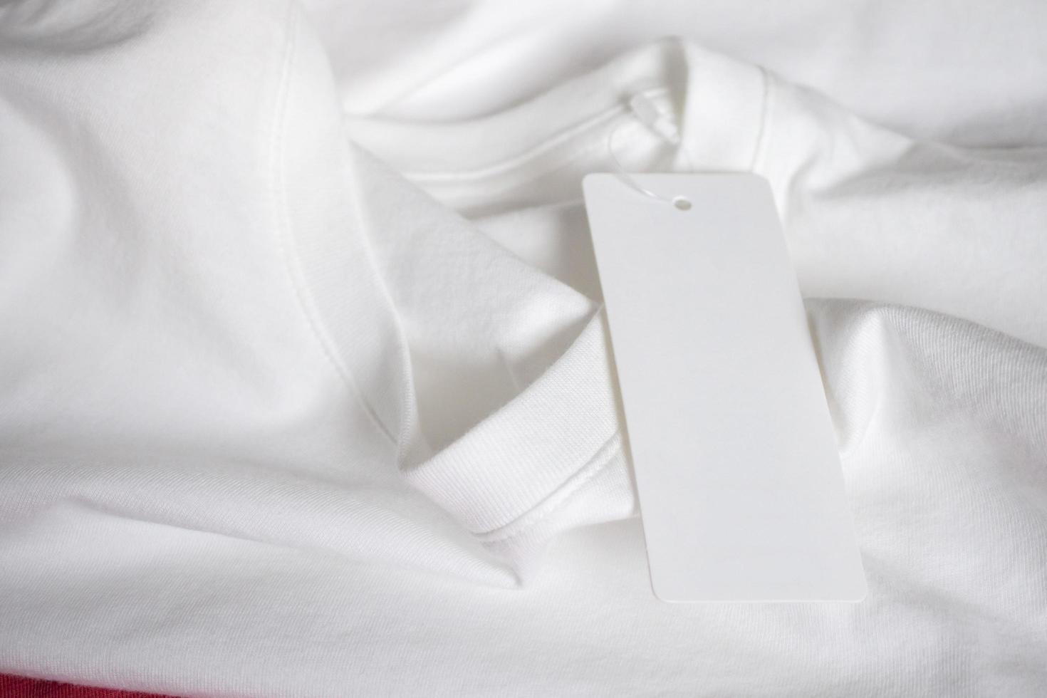 Blank price tag label on white t-shirt photo