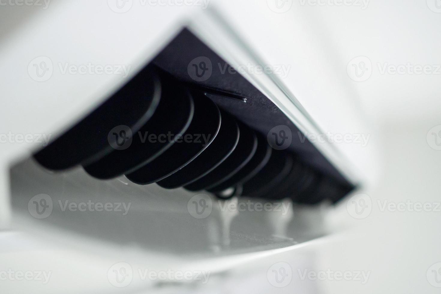 Air conditioner on white wall room interior background photo