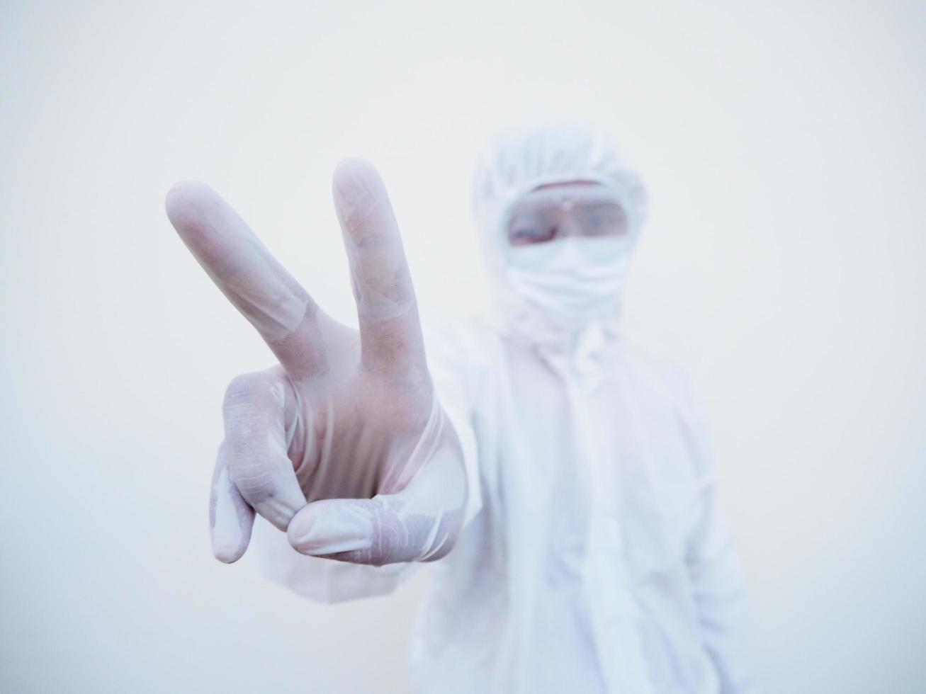 Doctor or scientist in PPE suite uniform  showing fight hand sign. coronavirus or COVID-19 with looking forward isolated white background photo