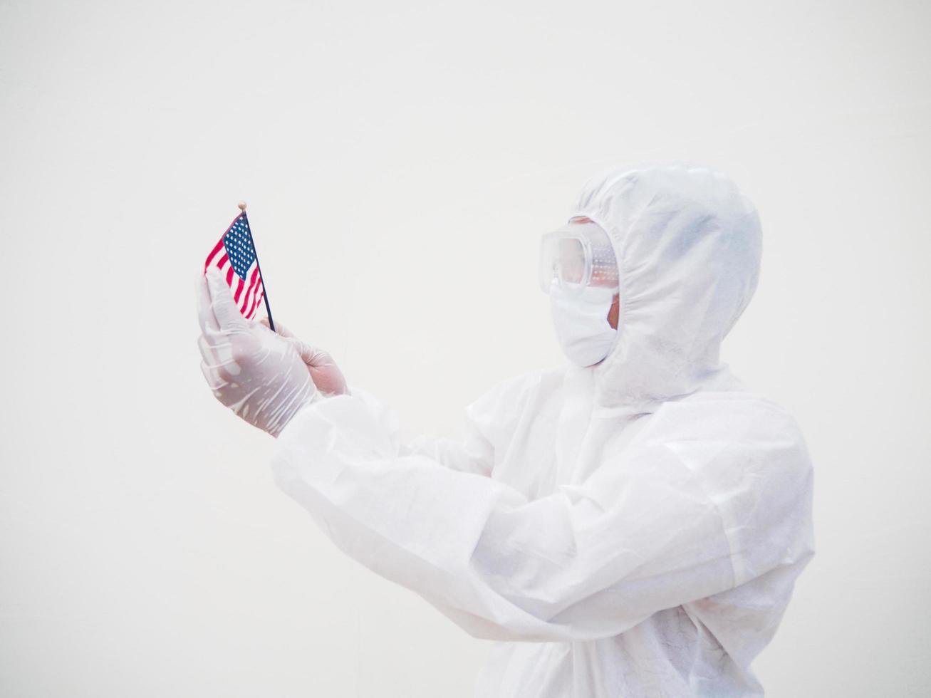 Portrait of doctor or scientist in PPE suite uniform holding national flag of United states of America. COVID-19 concept isolated white background photo