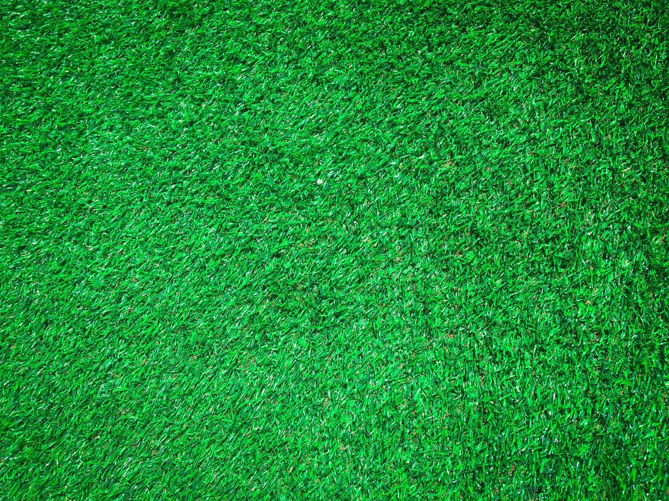 Artificial green lawn backyard for background. Texture for design photo