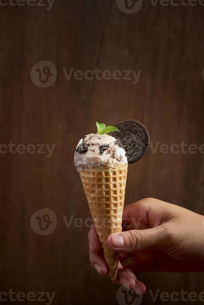 Sweet homemade ice cream with cookies in cone, selective focus photo