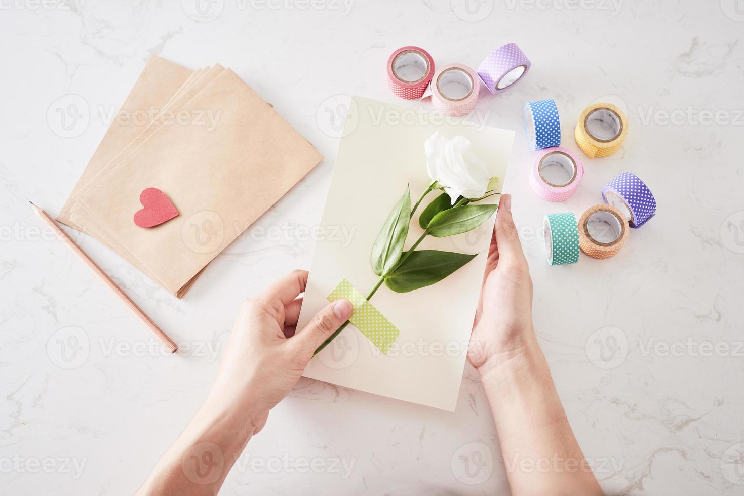 Hands of woman making birthday card, view from the top photo