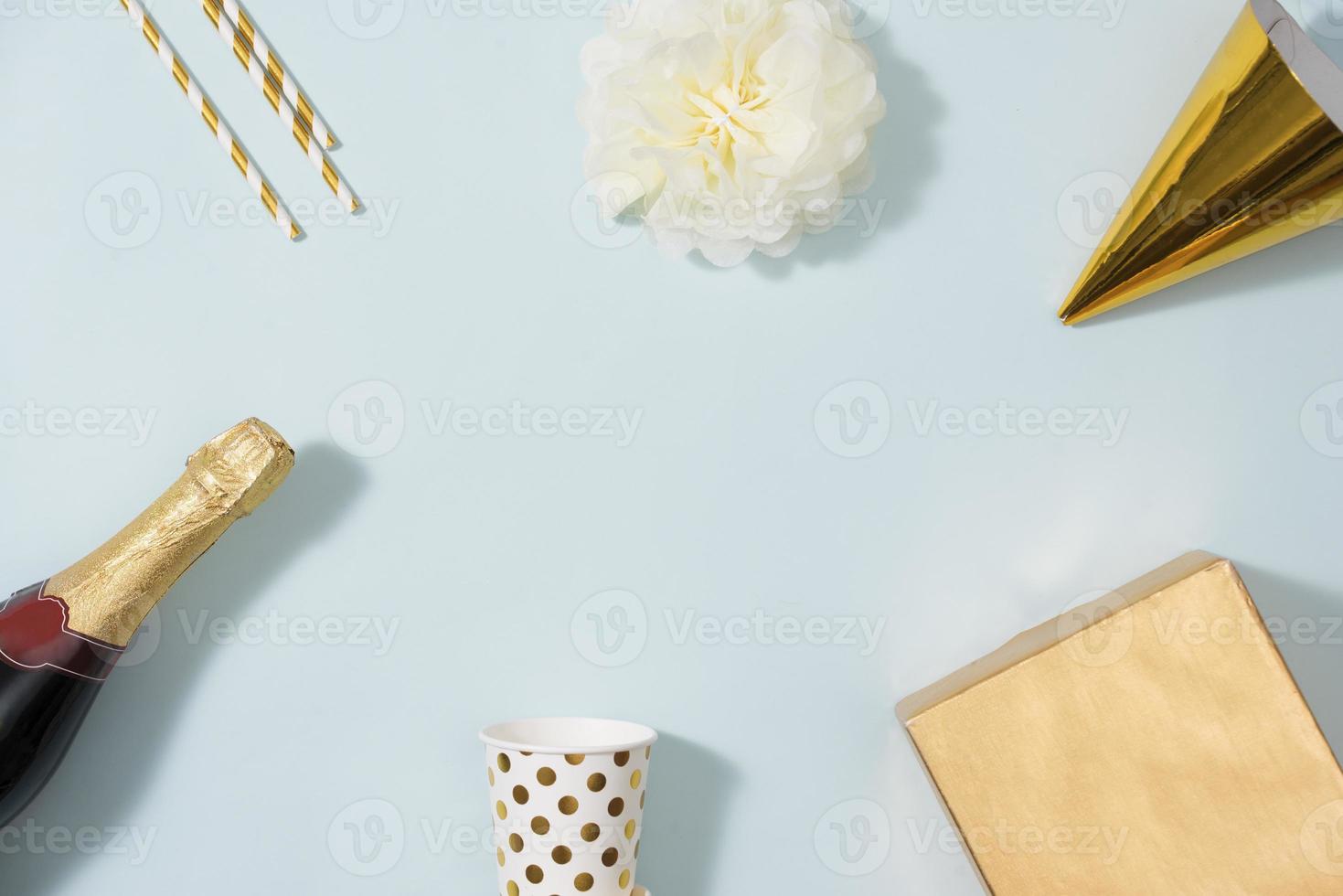 Flat lay Christmas or party background with gift boxs, champagne bottle, bows, decorations and wrapping paper in gold . Flat lay, top view photo