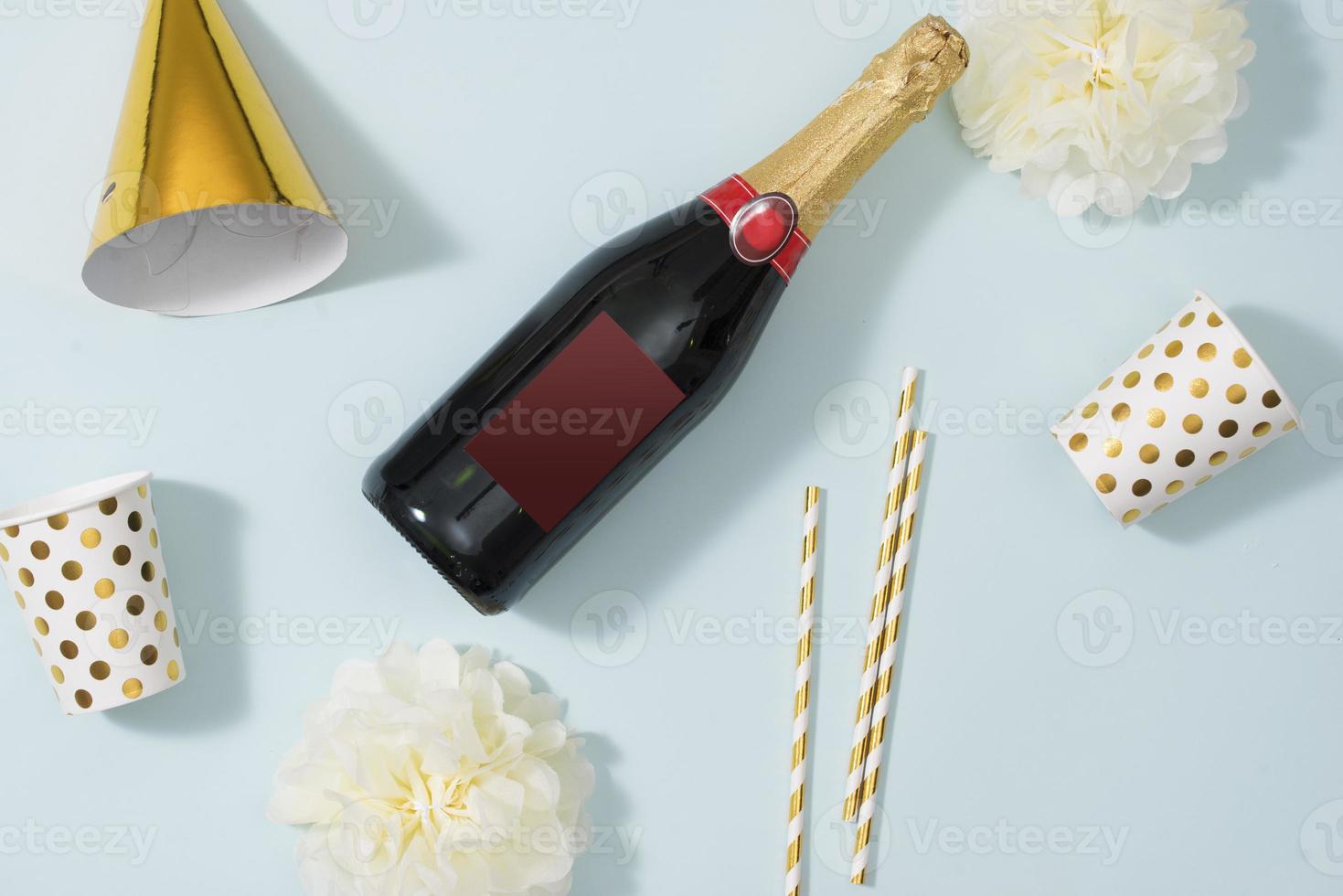 Flat lay Christmas or party background with gift boxs, champagne bottle, bows, decorations and wrapping paper in gold . Flat lay, top view photo