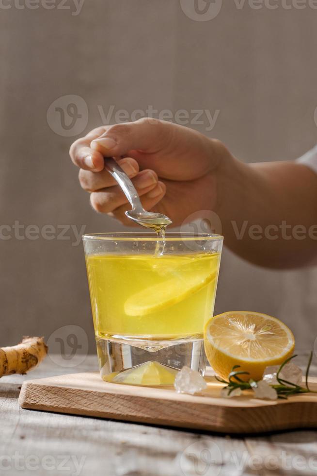 refreshing citrus lemonade,summer drink. Lemonade with fresh lemon on wooden background photo