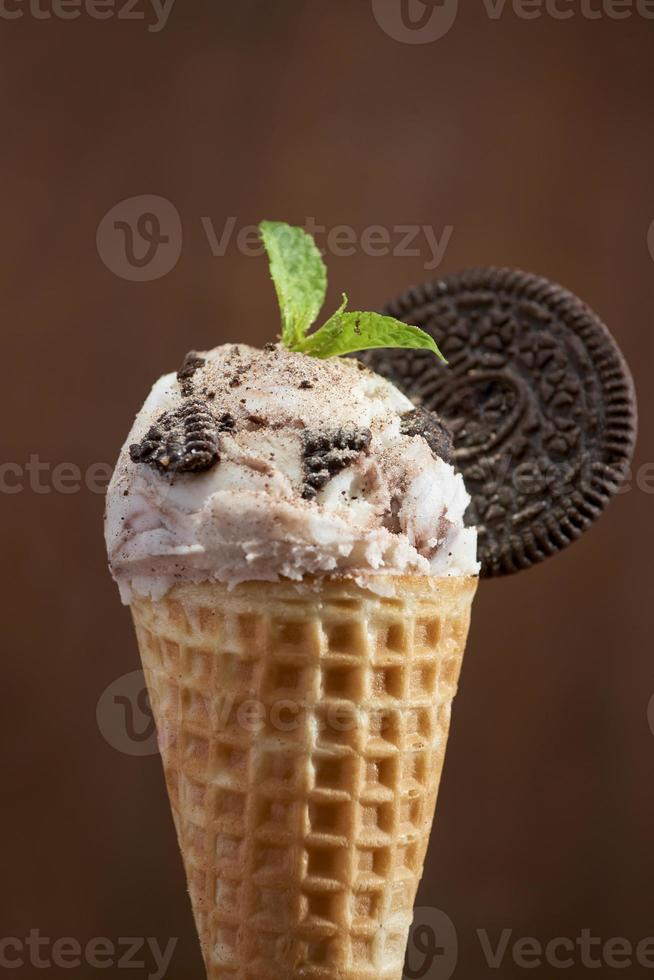 Sweet homemade ice cream with cookies in cone, selective focus photo