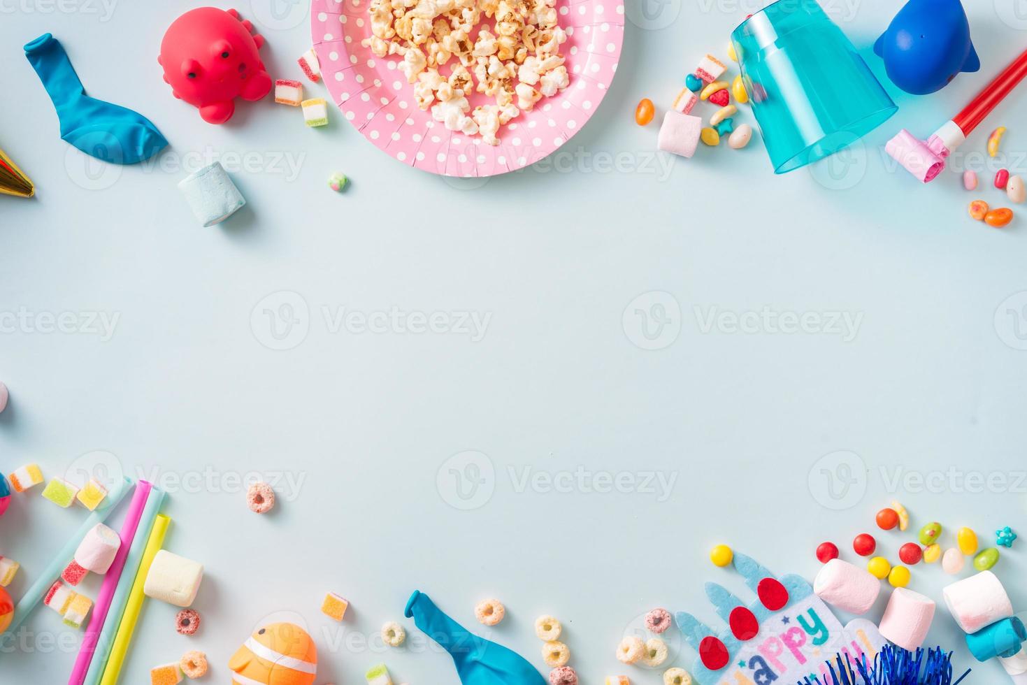 Holiday frame or background with colorful balloon, gift, confetti, silver star, carnival cap and streamer. Flat lay style. Birthday or party greeting card with copy space. photo