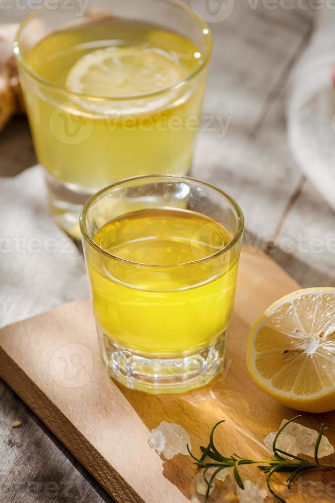 refreshing citrus lemonade,summer drink. Lemonade with fresh lemon on wooden background photo