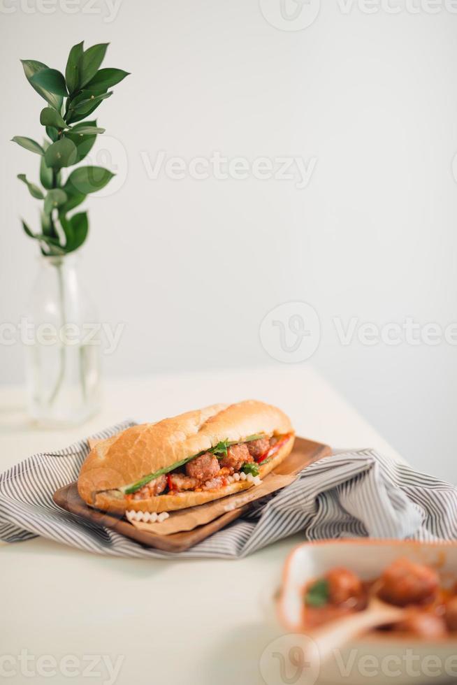 Banh Mi Xiu Mai Vietnamese sandwich with meatballs in tomato sauce