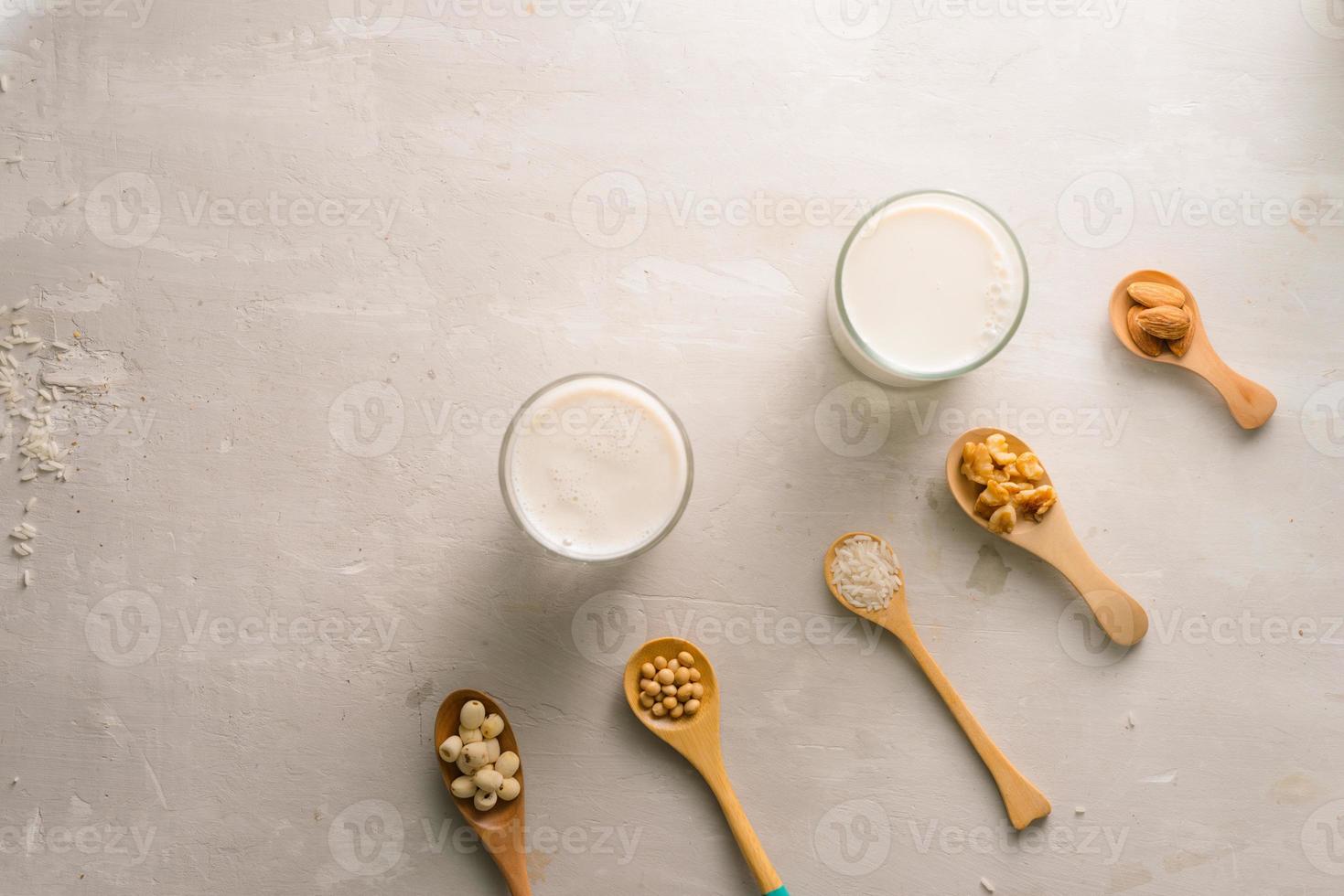 Glasses of milk with nuts Macadamia, almond, soy, rice, lotus. Top view. photo
