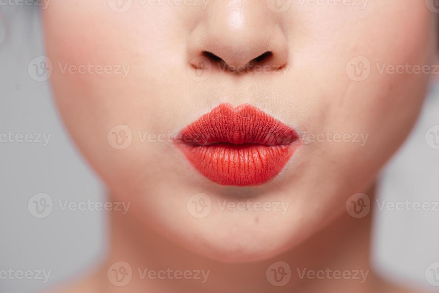 Close-up beauty portrait of woman face with sexy red lips photo