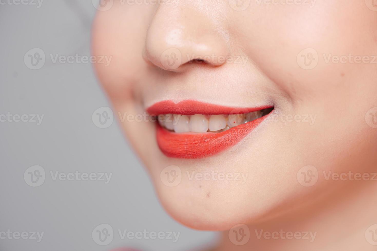 Close-up beauty portrait of woman face with sexy red lips photo