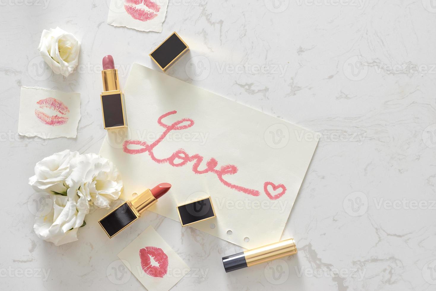 Pink Valentines day flat lay with a lipstick kiss and flowers. Top view photo