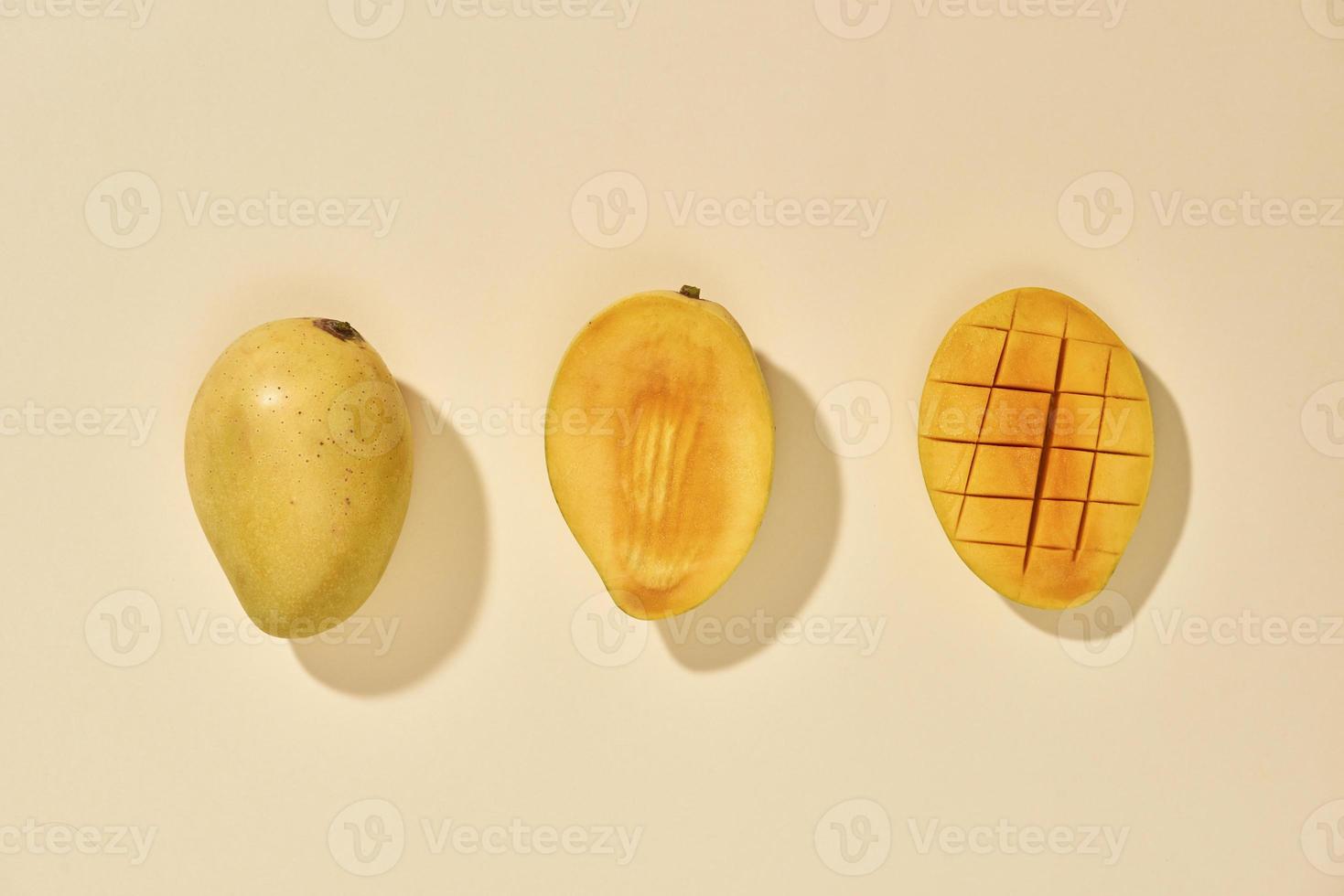 Fresh and beautiful mango fruit with sliced diced mango chunks on pastel background, copy space text space, blank for text, top view. photo