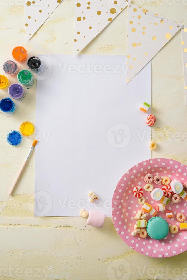 Party management and organization concept with sweets, confetti and blank pages. Creative celebration flat lay with copy space. photo