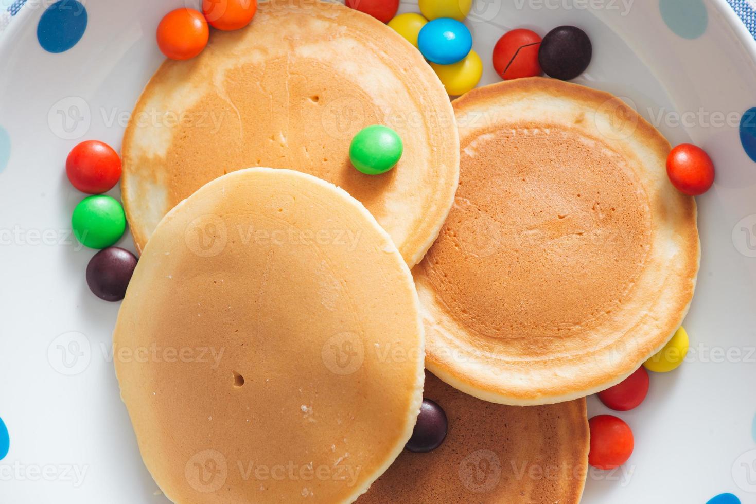 Children's breakfast or dessert - pancake with colorful candies. photo