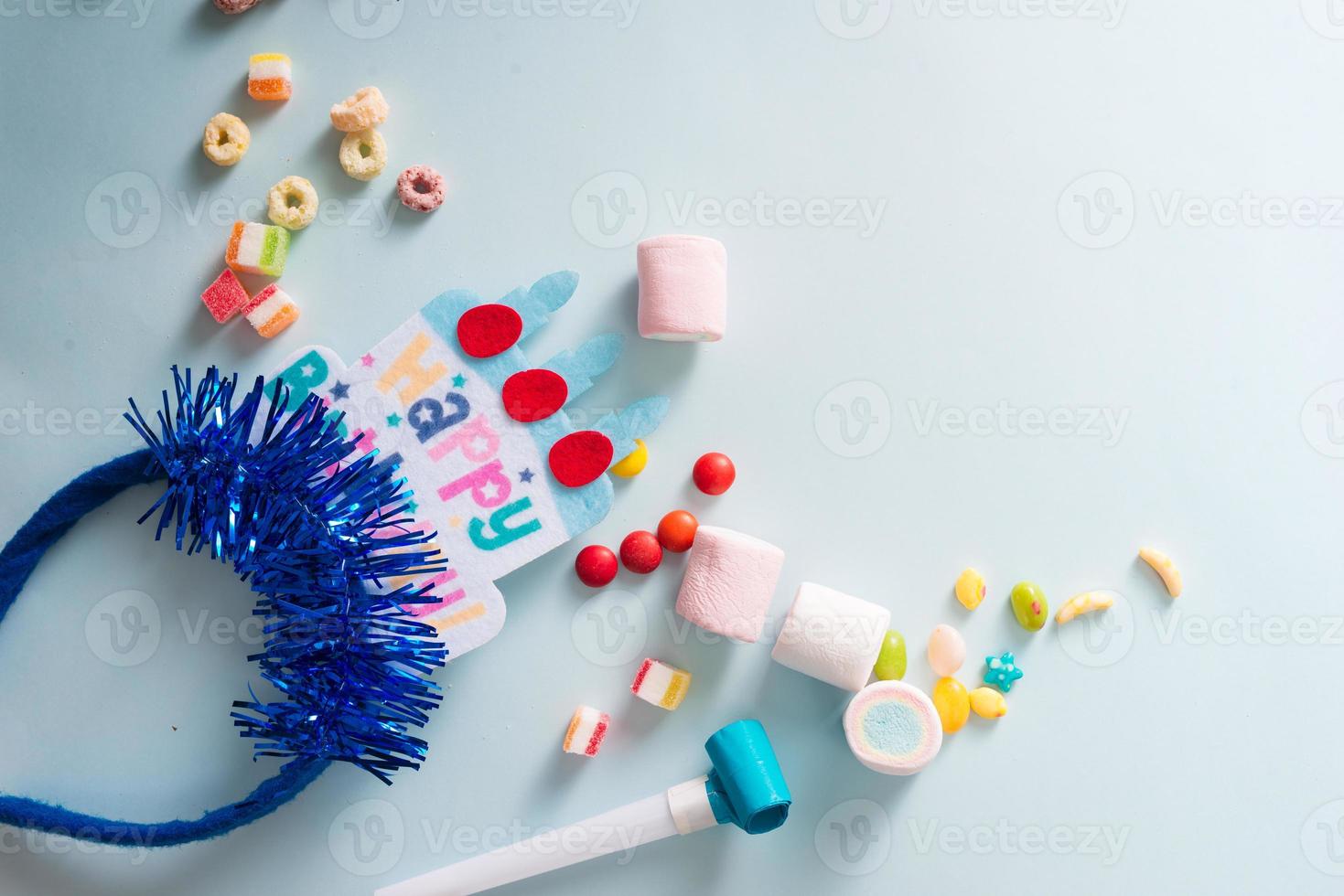 Colorful frame with party items on blue background. Happy birthday concept photo