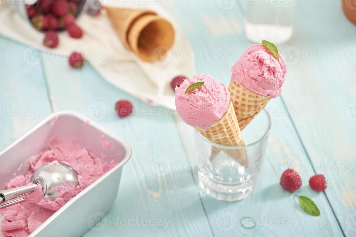 Homemade raspberry ice cream in waffle cones. photo