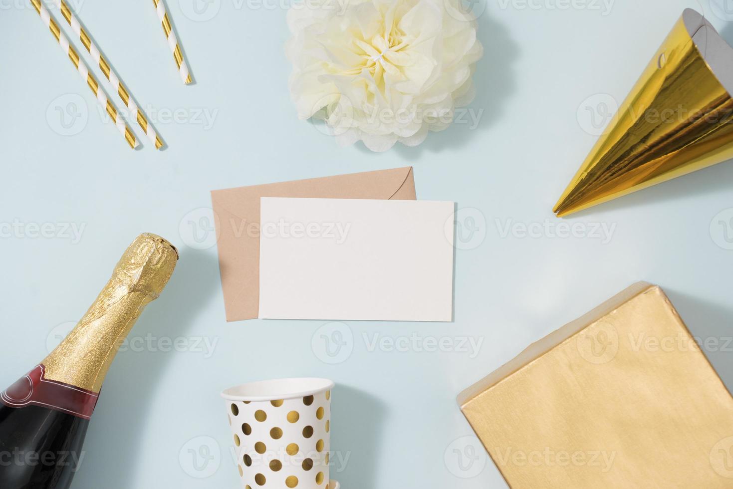 Flat lay Christmas or party background with gift boxs, champagne bottle, bows, decorations and wrapping paper in gold . Flat lay, top view photo