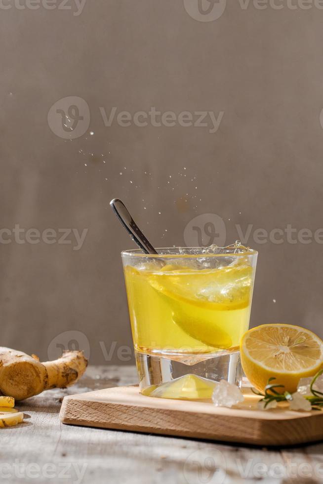 refreshing citrus lemonade,summer drink. Lemonade with fresh lemon on wooden background photo