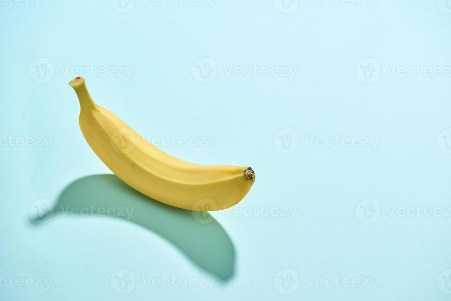 Ripe banana isolated on blue background photo