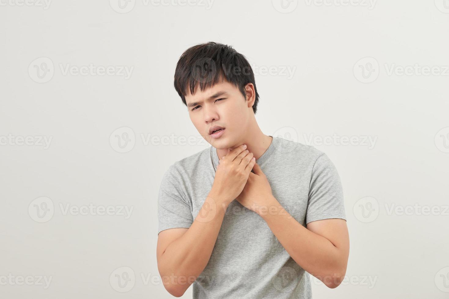 Young Asian man having sore throat photo