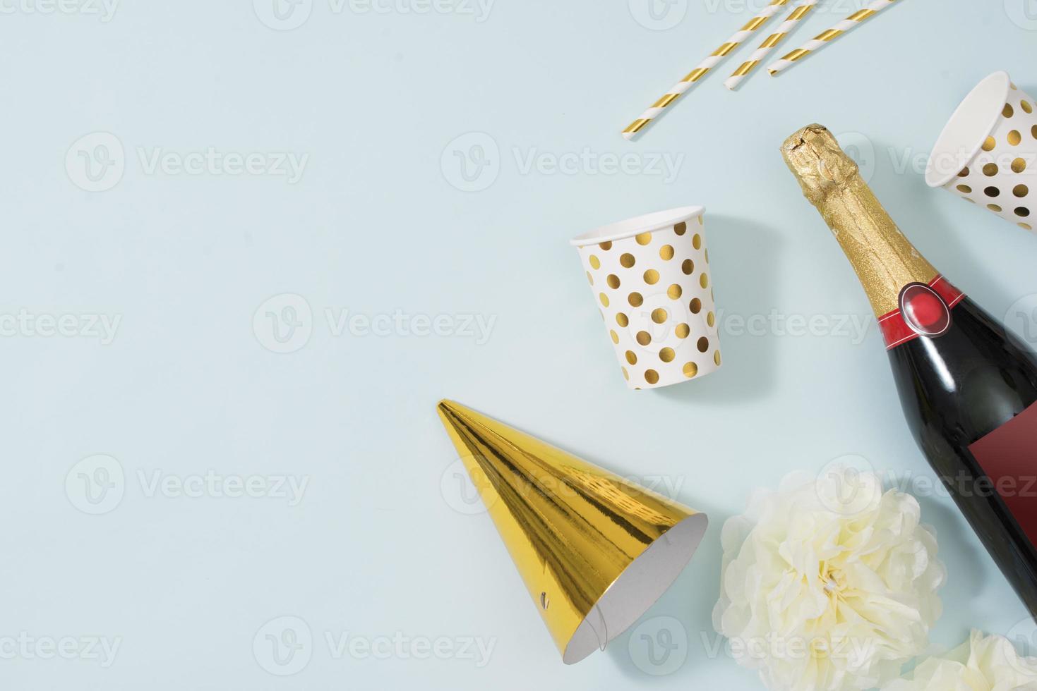 Flat lay Christmas or party background with gift boxs, champagne bottle, bows, decorations and wrapping paper in gold . Flat lay, top view photo