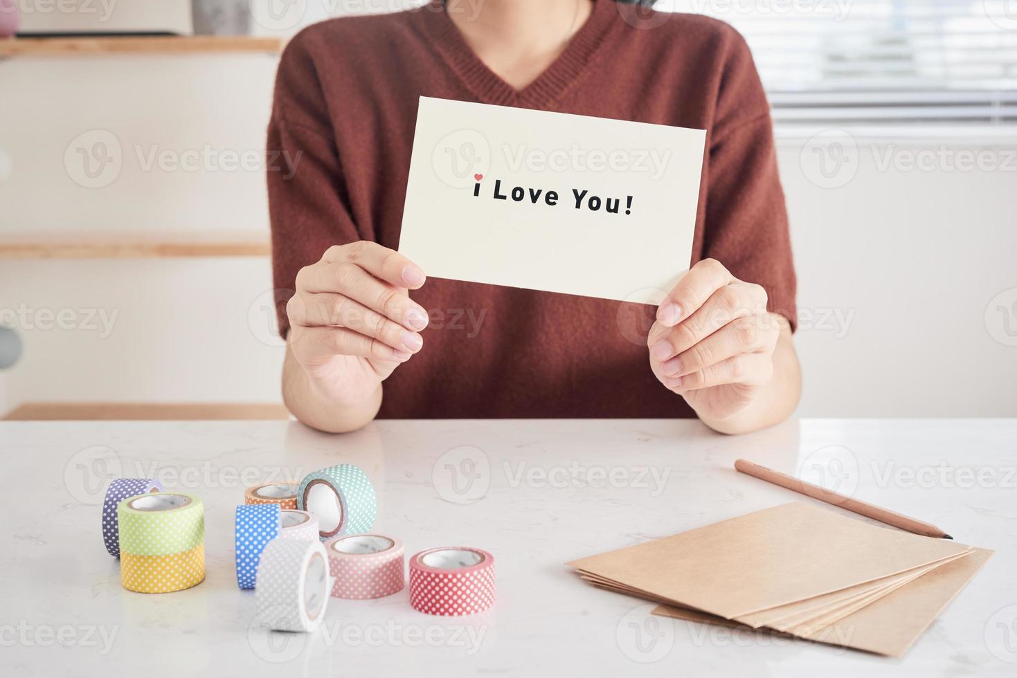 hands holding greeting card with phrase letters i love you prepared for sweetheart photo