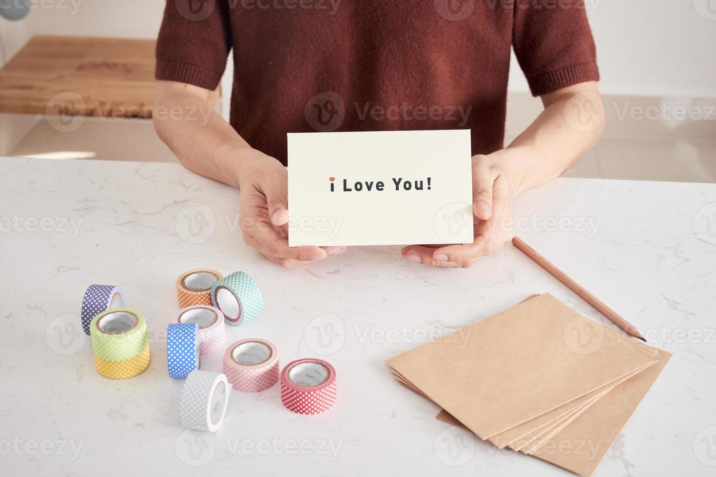 manos sosteniendo una tarjeta de felicitación con letras de frase te amo preparada para cariño foto