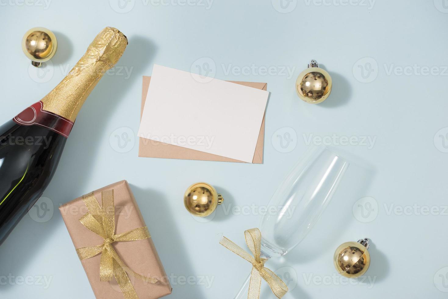 Clipboard and Bottles of champagne with golden decorations. Flat lay, top view trendy holiday concept. photo