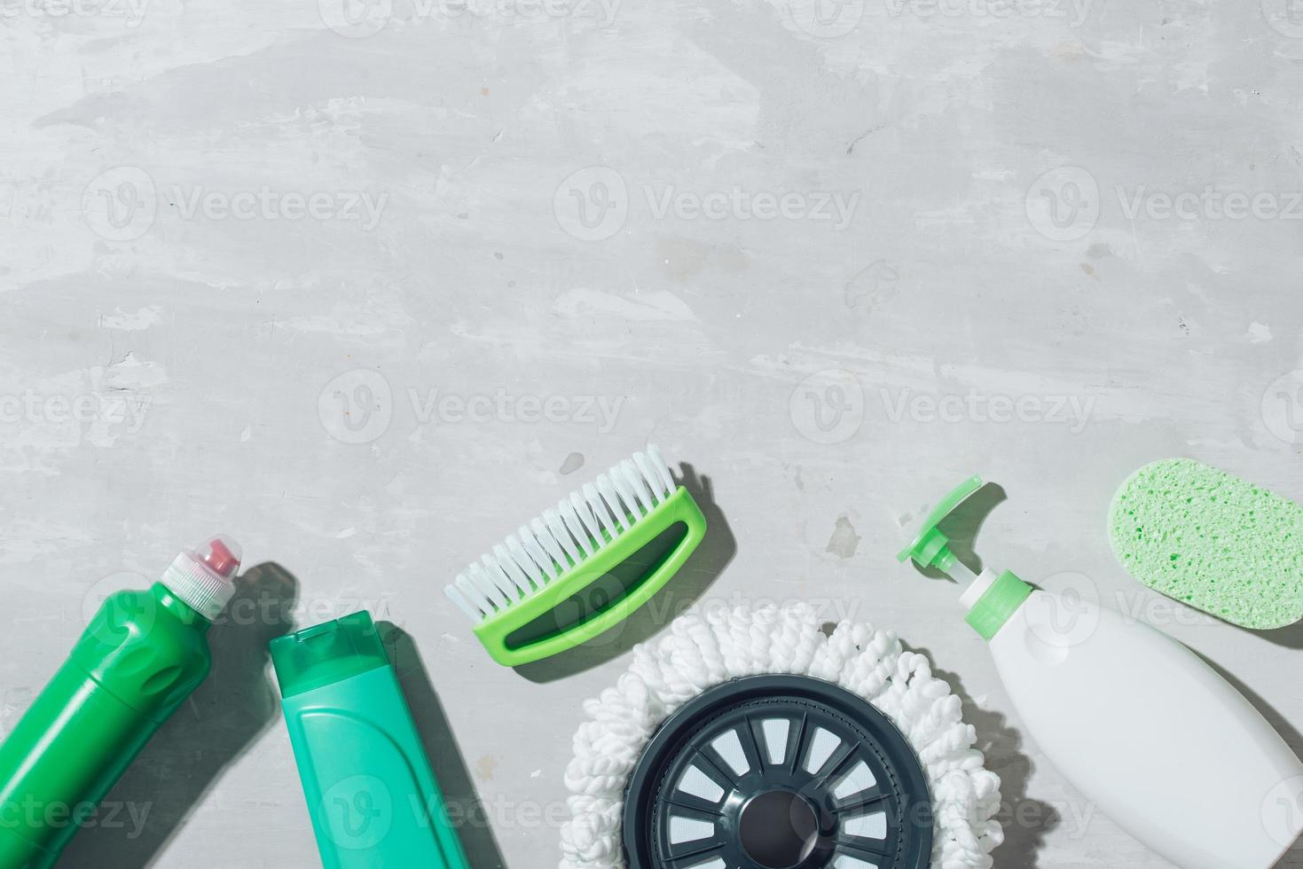 House cleaning products on wooden table. Salt pelets, baking soda sodium bicarbonate, detergent, spray photo