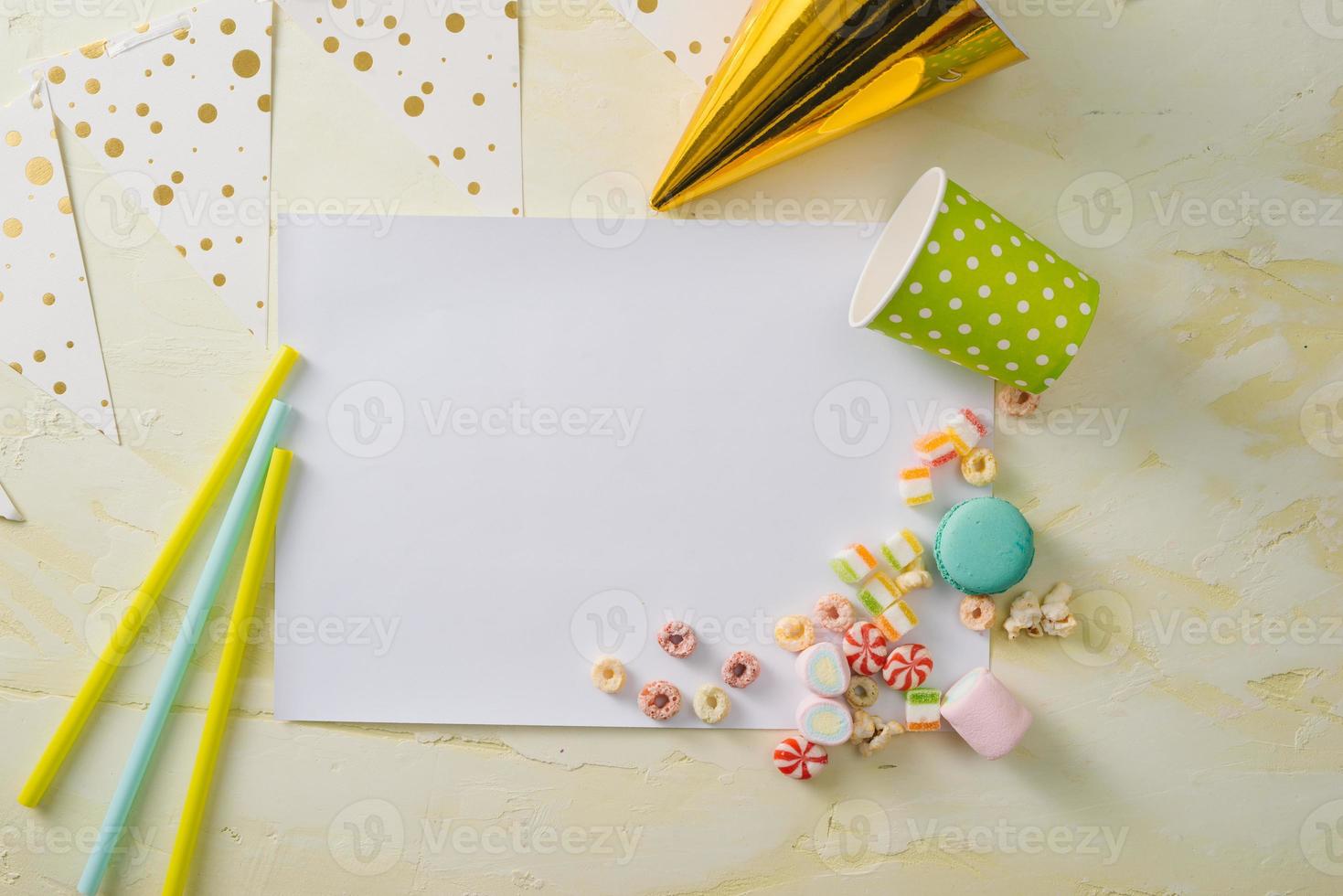 Party management and organization concept with sweets, confetti and blank pages. Creative celebration flat lay with copy space. photo