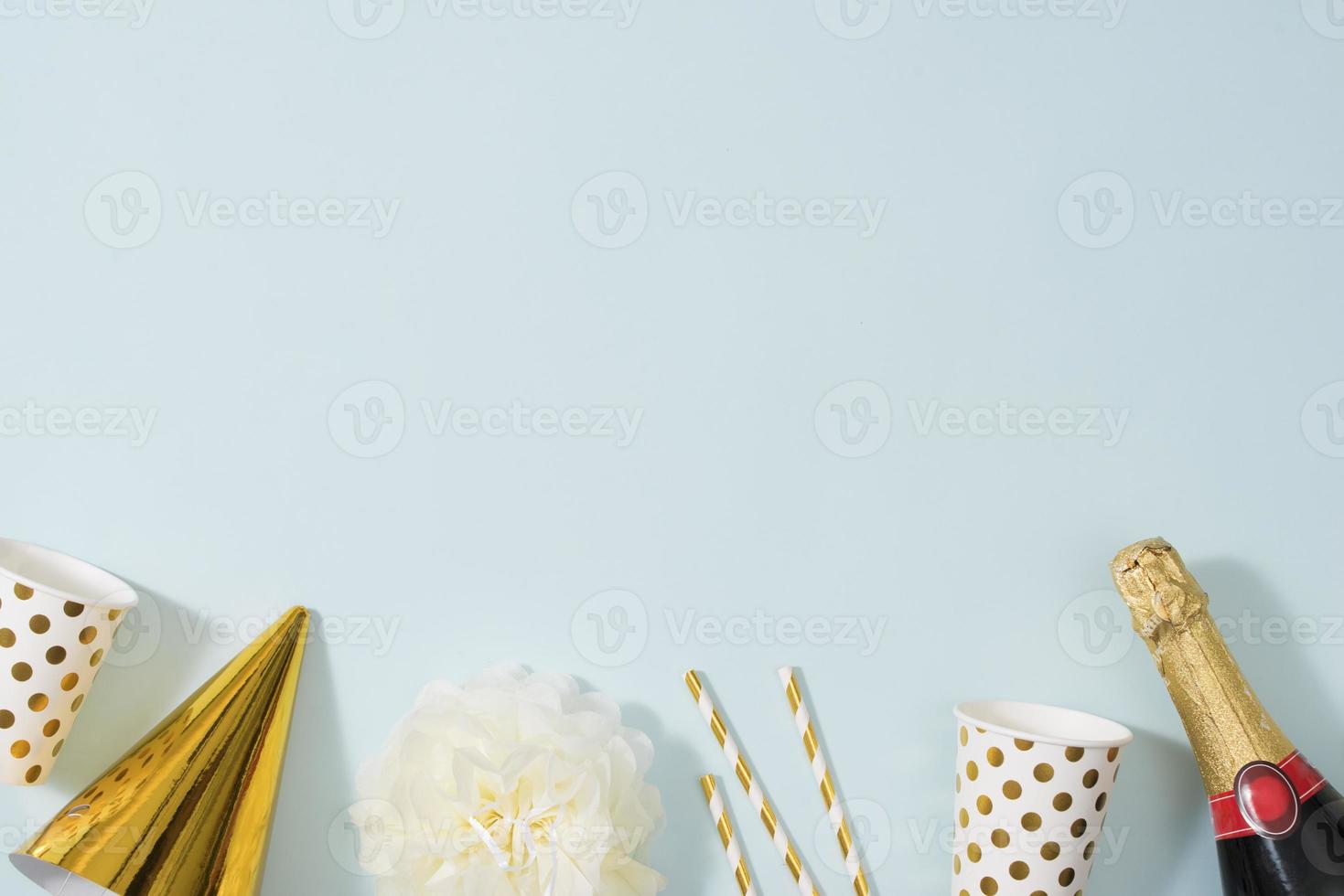 Flat lay Christmas or party background with gift boxs, champagne bottle, bows, decorations and wrapping paper in gold . Flat lay, top view photo