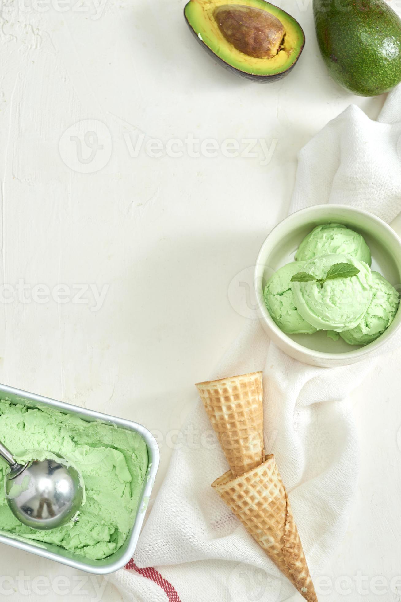homemade organic avocado ice cream, with ice cream cones. On a grey
