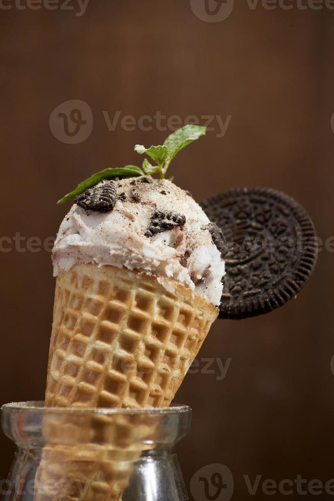 Sweet homemade ice cream with cookies in cone, selective focus photo