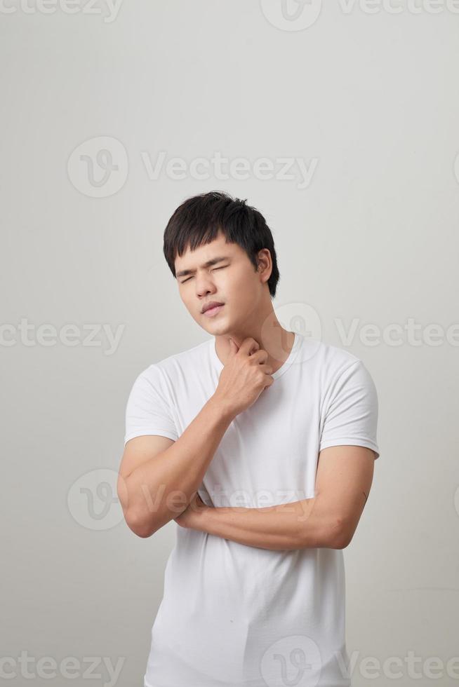 Man has a terrible pain in throat because of flu. He lost his voice and can not speak photo