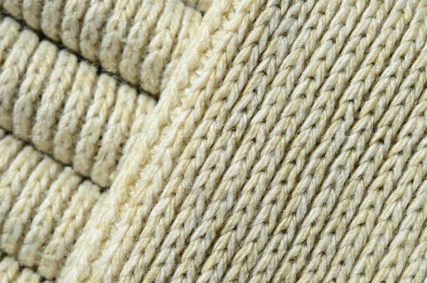 Composition of a soft yellow knitted sweater. Macro texture of bindings in yarns photo