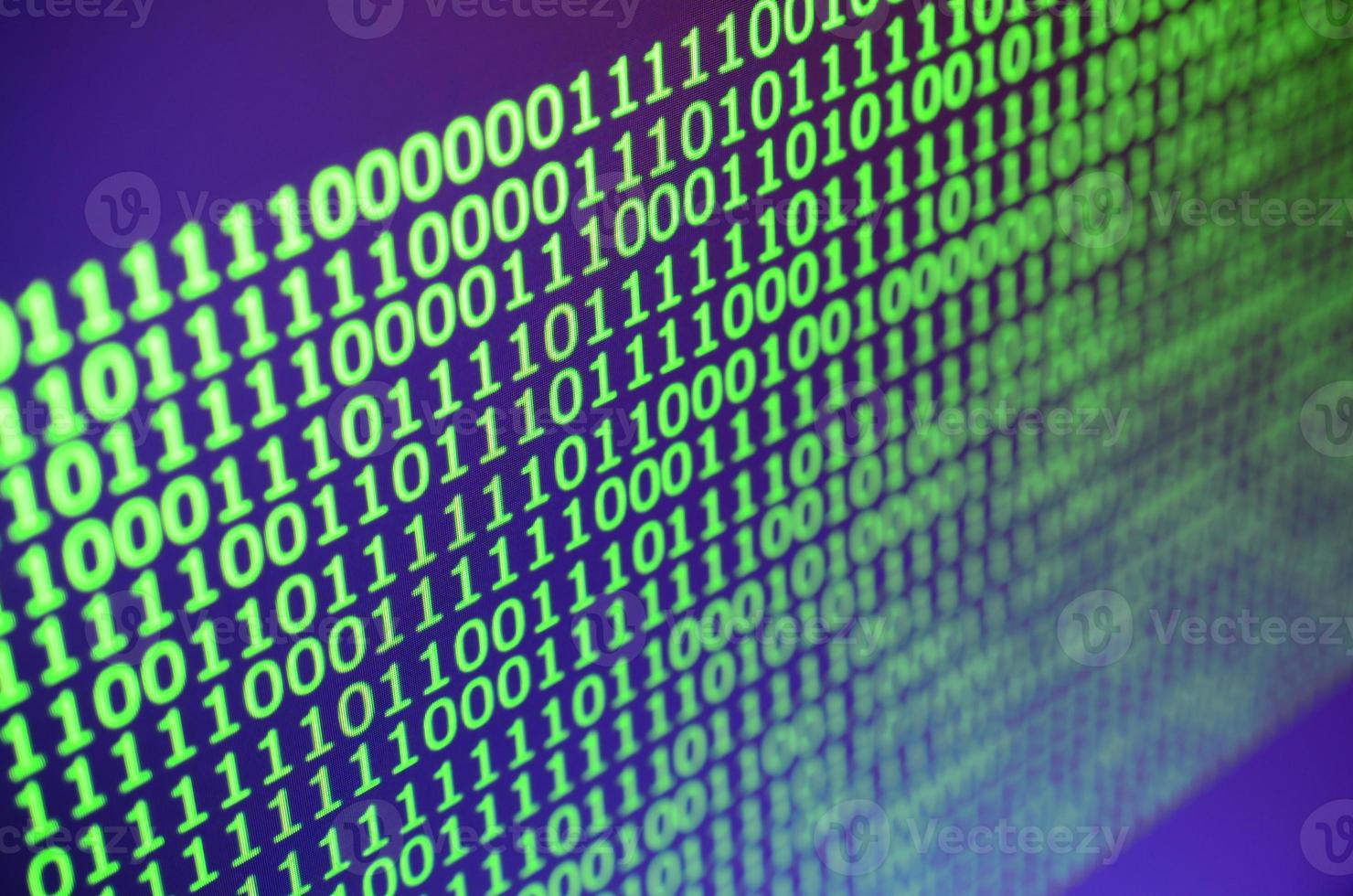 Macro shot of binary code on the monitor of an office computer. The concept of the programmer's work. The flow of digital information strings photo