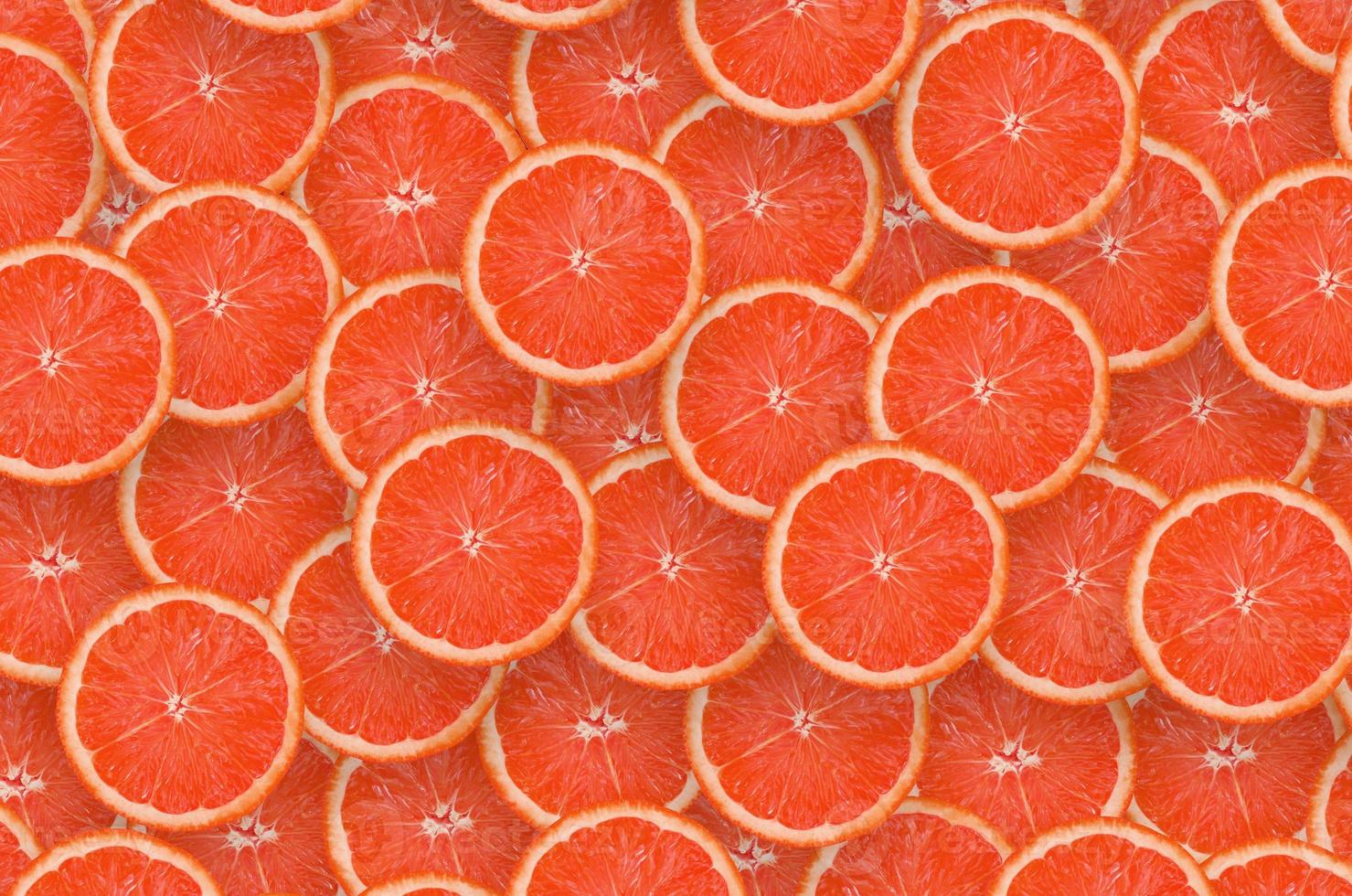 Pattern of red grapefruit citrus slices. Citrus flat lay photo