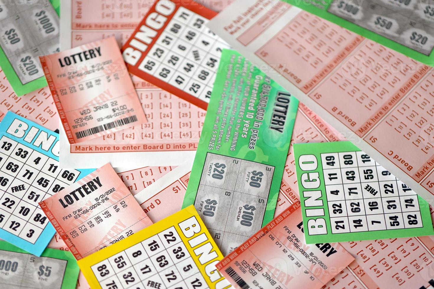 Many used lottery tickets, bills with numbers and bingo playing boards in big pile. Gambling and lottery paper stuff photo