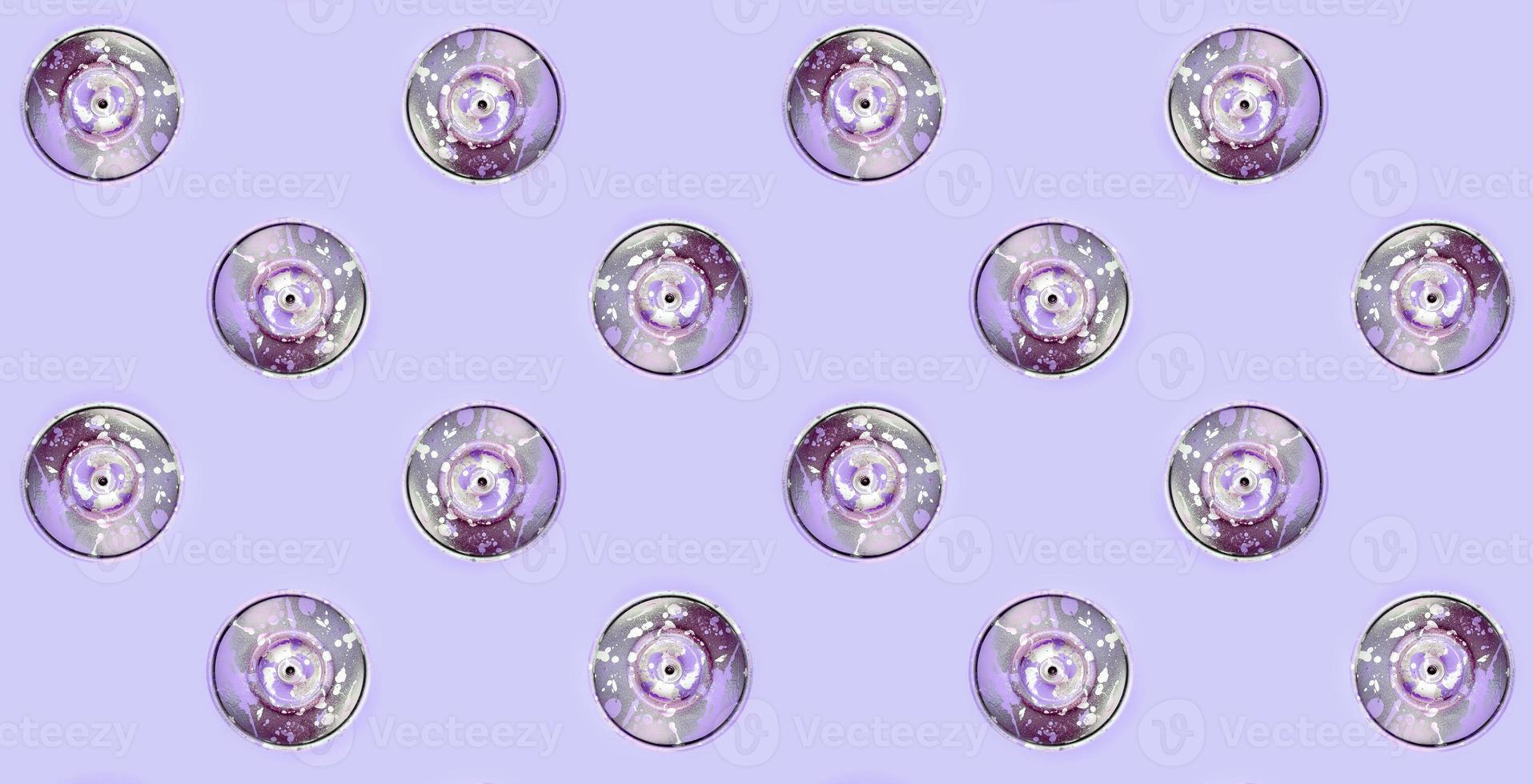 Many used spray cans for graffiti drawing lies on a pastel colored backgroung. Street art painting concept. Minimal flat lay pattern. Top view photo