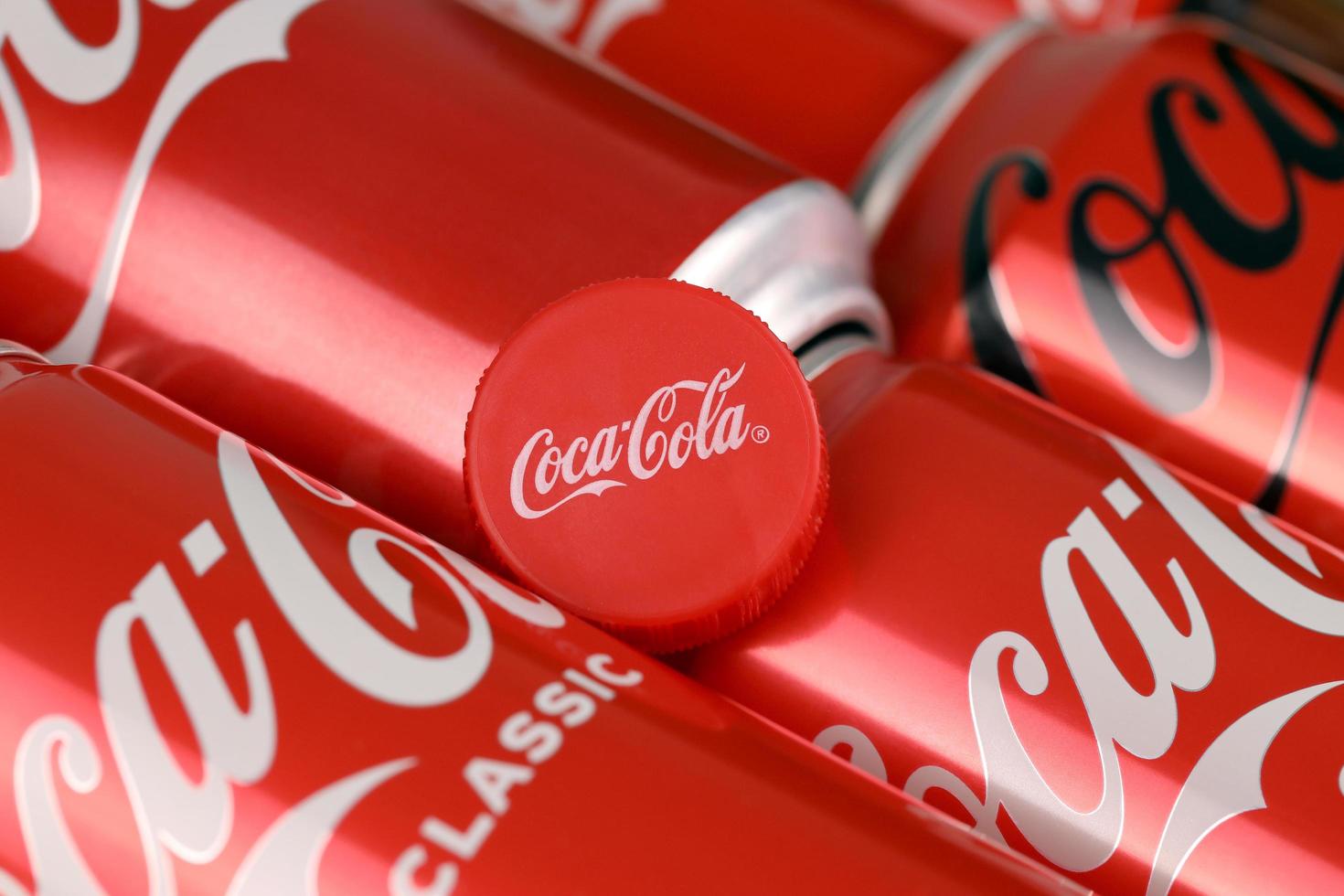 KHARKIV, UKRAINE - DECEMBER 16, 2021 Coca Cola production with classic company logo. Coca-Cola is a carbonated soft drink sold in stores, throughout the world. photo