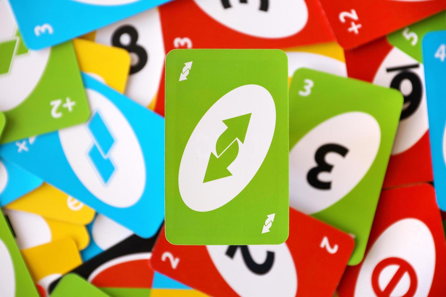 TERNOPIL, UKRAINE - MAY 15, 2022 Many colorful UNO game cards. UNO is an American shedding-type card game that is played with a specially printed deck photo